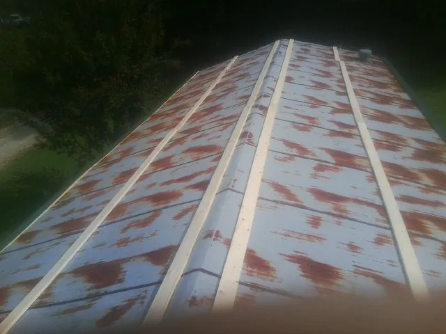 Rusted metal roof panels with new wood purlins before replacement — Storm Damage Roof Repair in Slippery Rock by Roofing Brothers