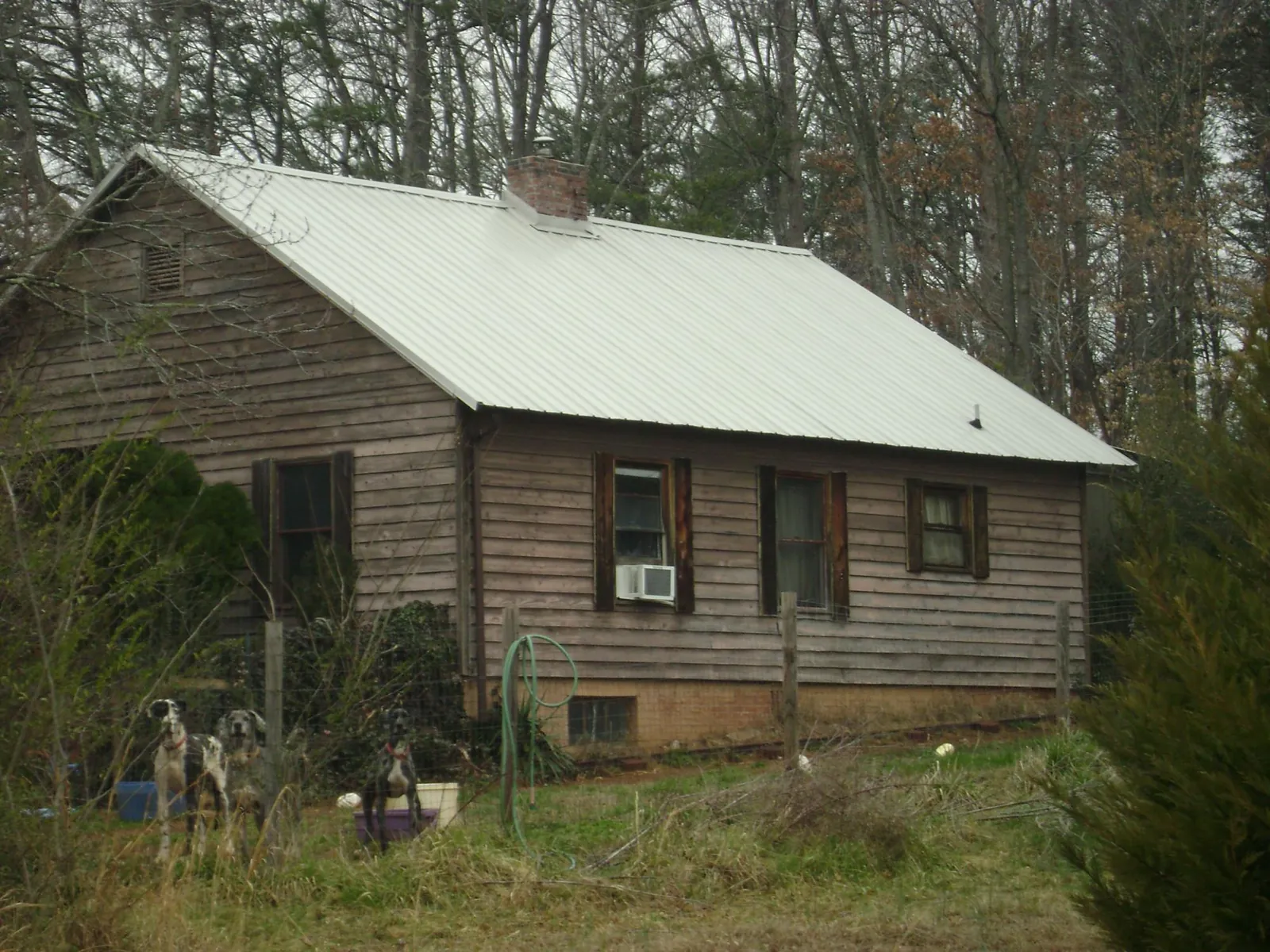 White metal roof on an old wood sided farmhouse, from a Metal Roof Installation job in Slippery Rock